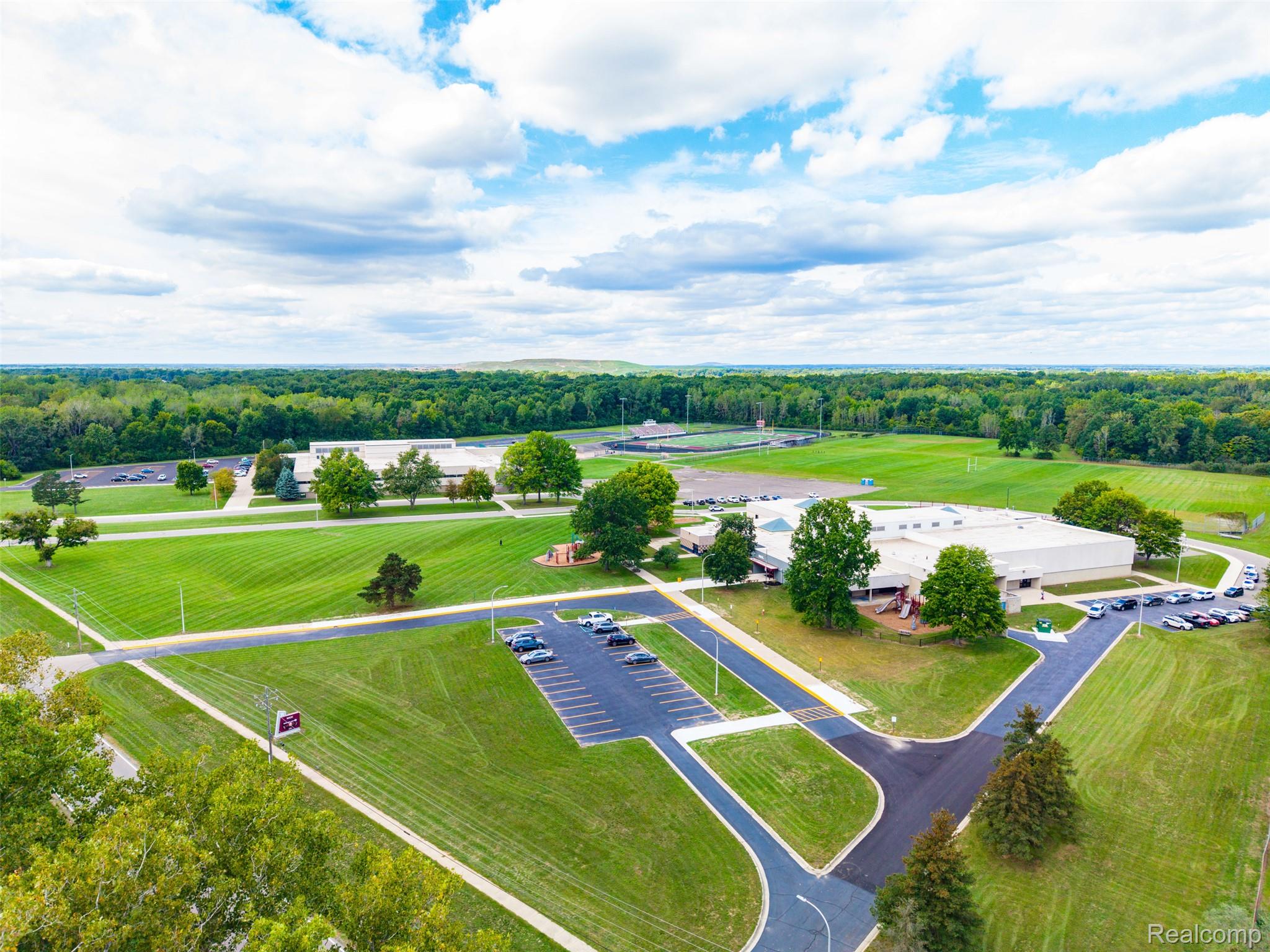 36739 Wick Road Romulus, MI 48174 - Photo 52 of 56 Expansive grounds featuring multiple buildings, paved parking areas, and mature trees