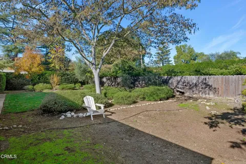 a view of backyard with swimming pool and green space