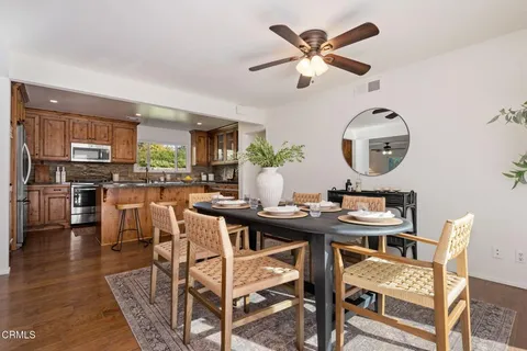 a kitchen with stainless steel appliances granite countertop a stove top oven a sink dishwasher and cabinets with wooden floor