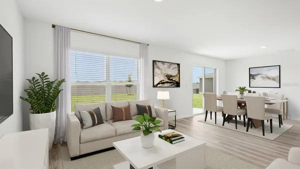 a living room with furniture potted plant and window