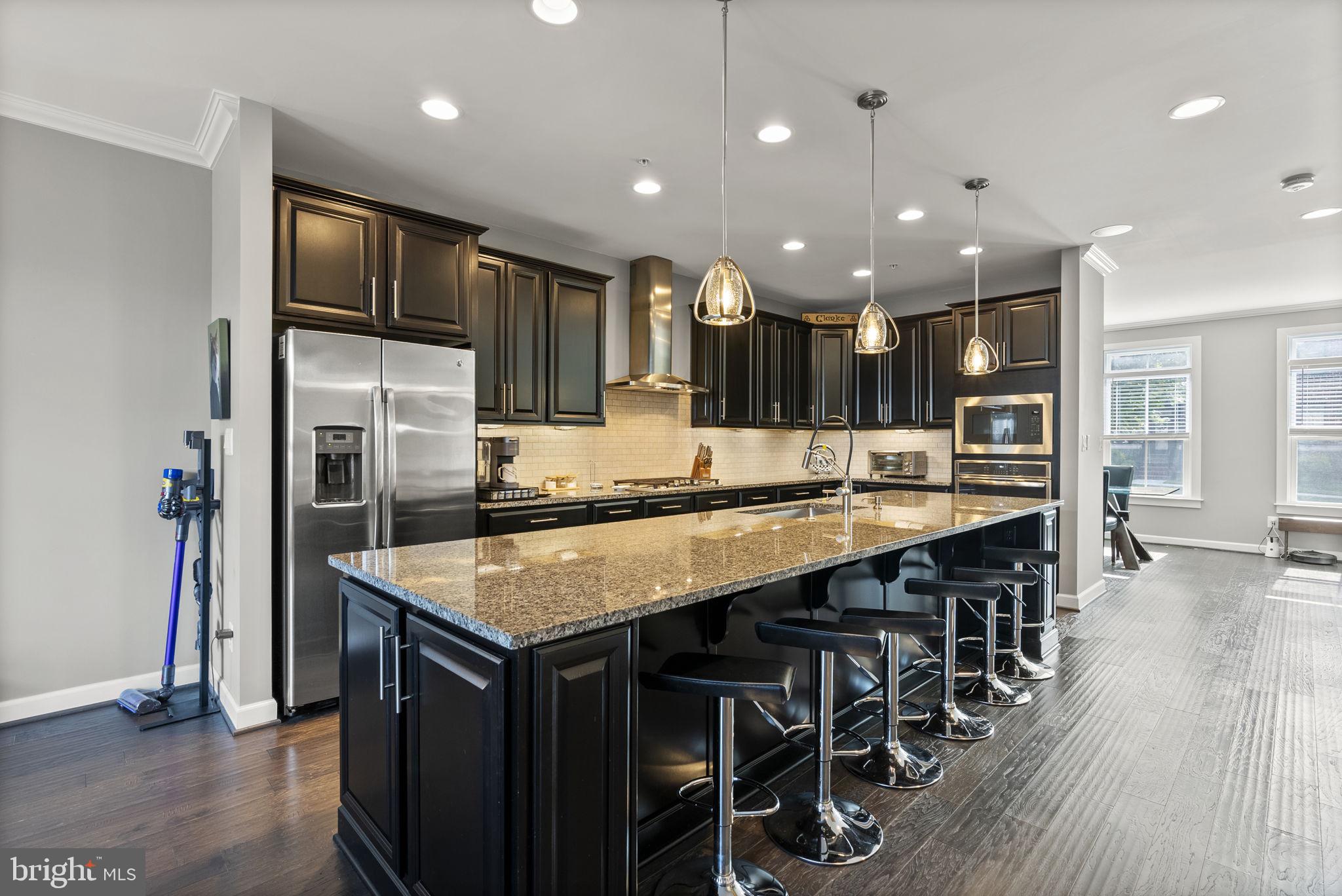 402 Redbridge Street Middle River, MD 21220 - Photo 13 of 49 a kitchen with stainless steel appliances granite countertop a kitchen island a stove and a refrigerator