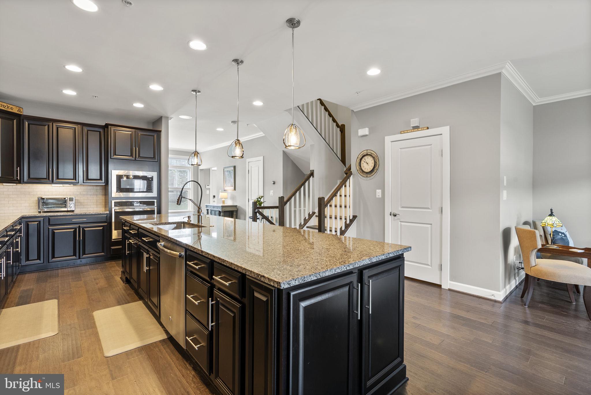 402 Redbridge Street Middle River, MD 21220 - Photo 14 of 49 a kitchen with stainless steel appliances granite countertop a sink a stove and a wooden floors