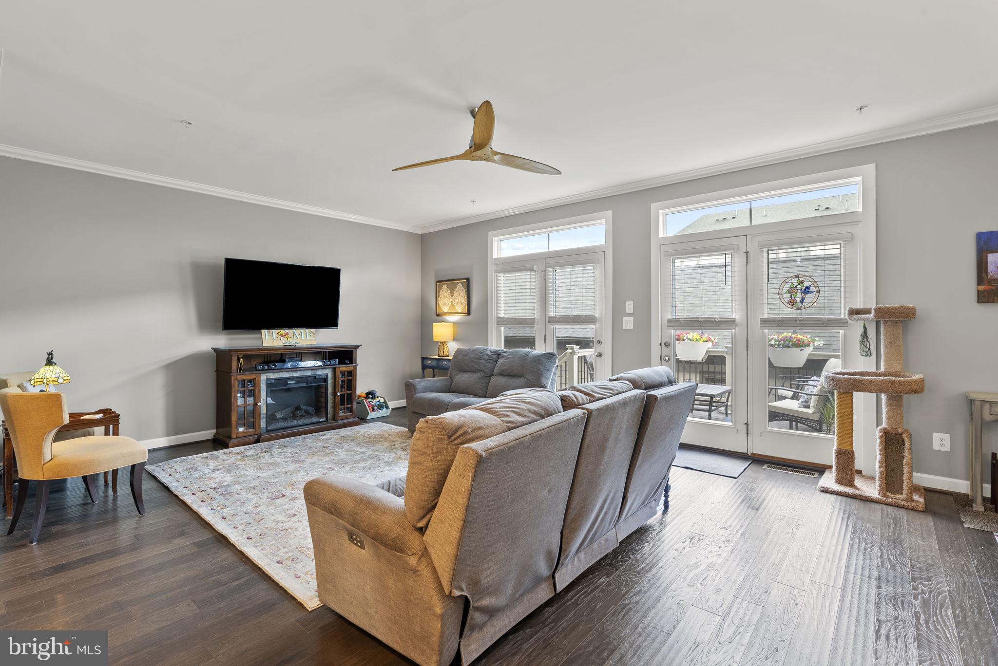 402 Redbridge Street Middle River, MD 21220 - Photo 15 of 49 a living room with furniture a flat screen tv and wooden floor