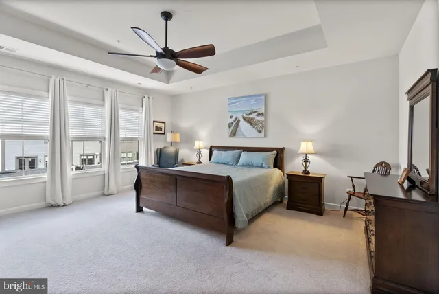 a spacious bedroom with a bed and a large window