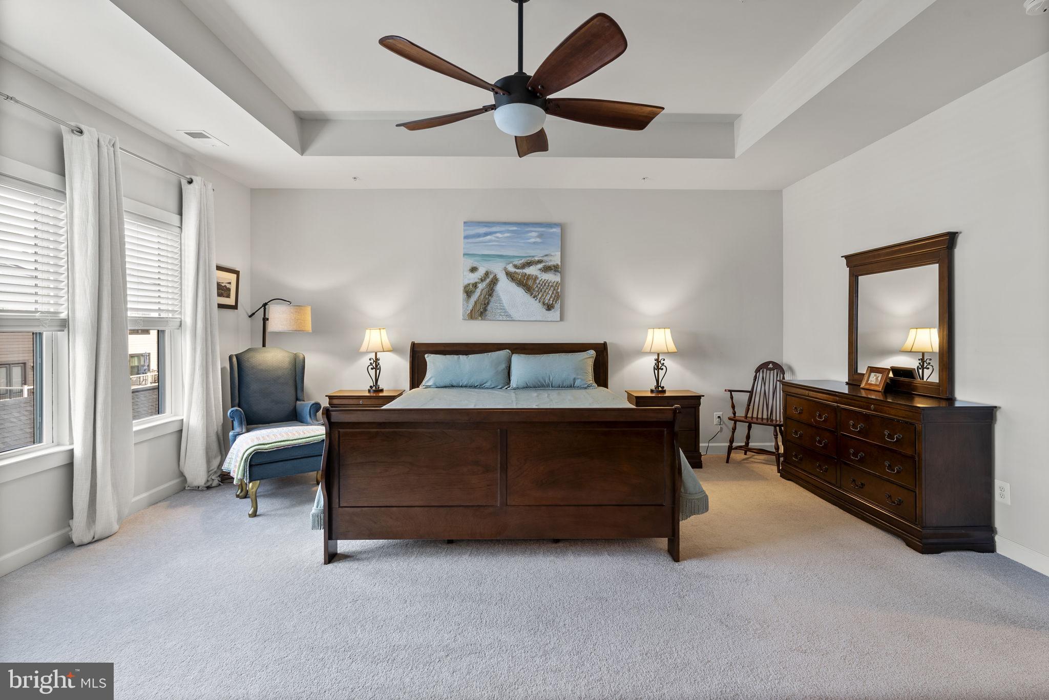 402 Redbridge Street Middle River, MD 21220 - Photo 22 of 49 a spacious bedroom with a bed and a chandelier