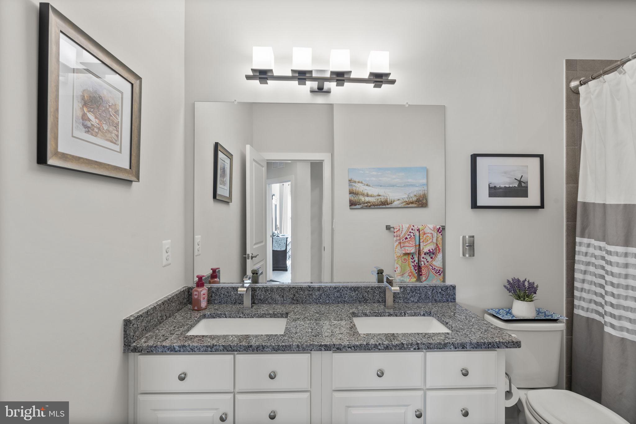 402 Redbridge Street Middle River, MD 21220 - Photo 29 of 49 a bathroom with double vanity sinks granite vanity and a mirror