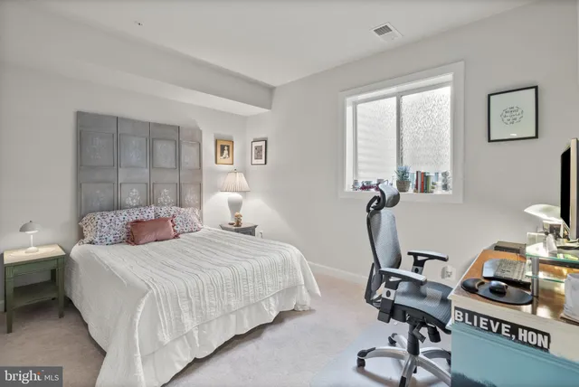 a bedroom with a bed and a desk