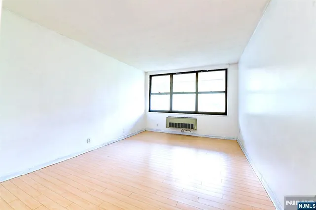 a bathroom with a granite countertop sink a large mirror and a toilet