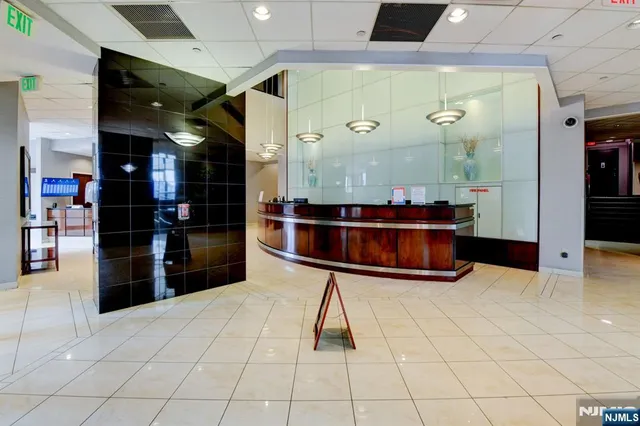 a living room with furniture pool table and a large window