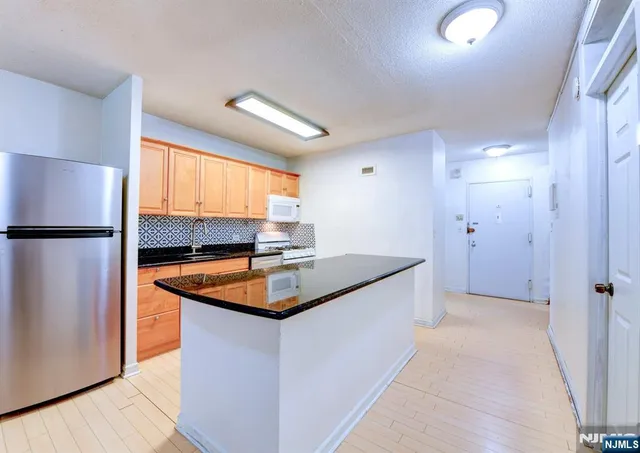 a view of a big room with wooden floor and a ceiling fan