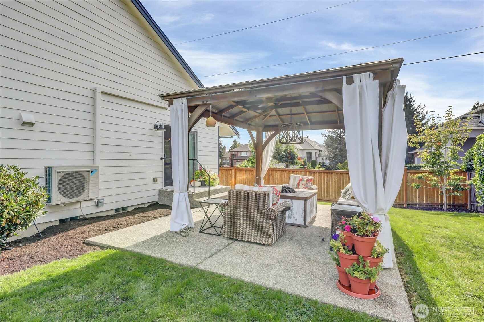 20615 39th Avenue Southeast Bothell, WA 98021 - Photo 30 of 37 a patio with table and chairs and potted plants