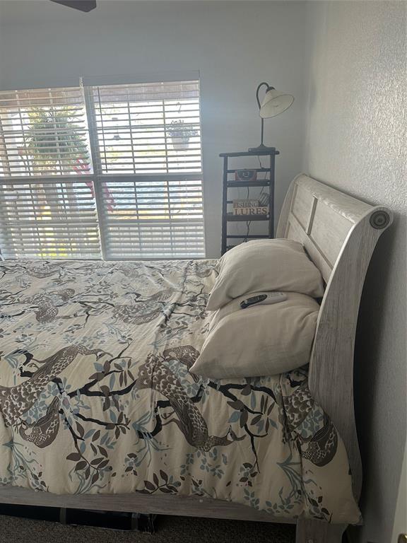 348 Lake Loop Bellevue, TX 76228 - Photo 11 of 11 a bed sitting in a bedroom next to a window