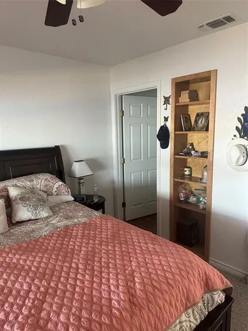 a bedroom with a bed and cabinets