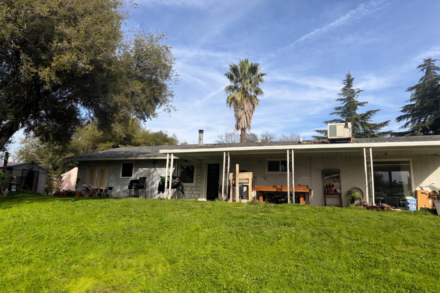 46300 Oonay Nation Road Coarsegold, CA 93614 - Photo 2 of 2 a view of a house with a yard and potted plants