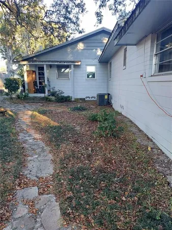 a front view of house with a garden