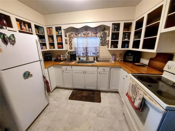 a kitchen with a sink a stove and a refrigerator
