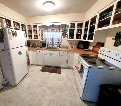 a kitchen with a refrigerator and a sink