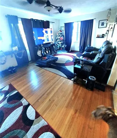 a living room with furniture and wooden floor