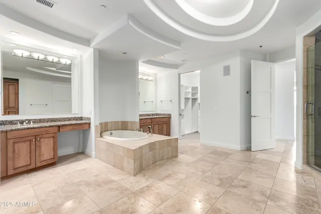 a spacious bathroom with a granite countertop tub sink and mirror