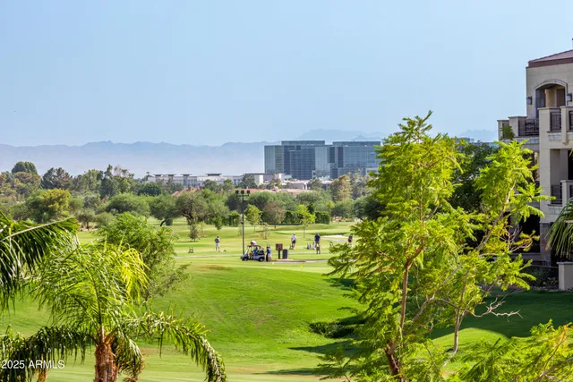 a view of a garden with a building in the background