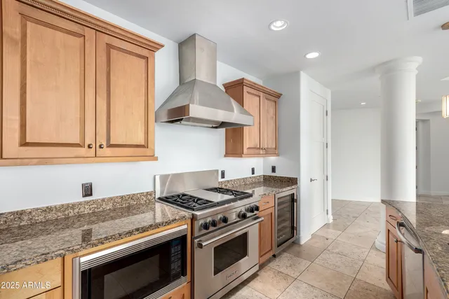 a kitchen with granite countertop a stove and a sink
