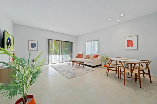 a living room with furniture and a potted plant