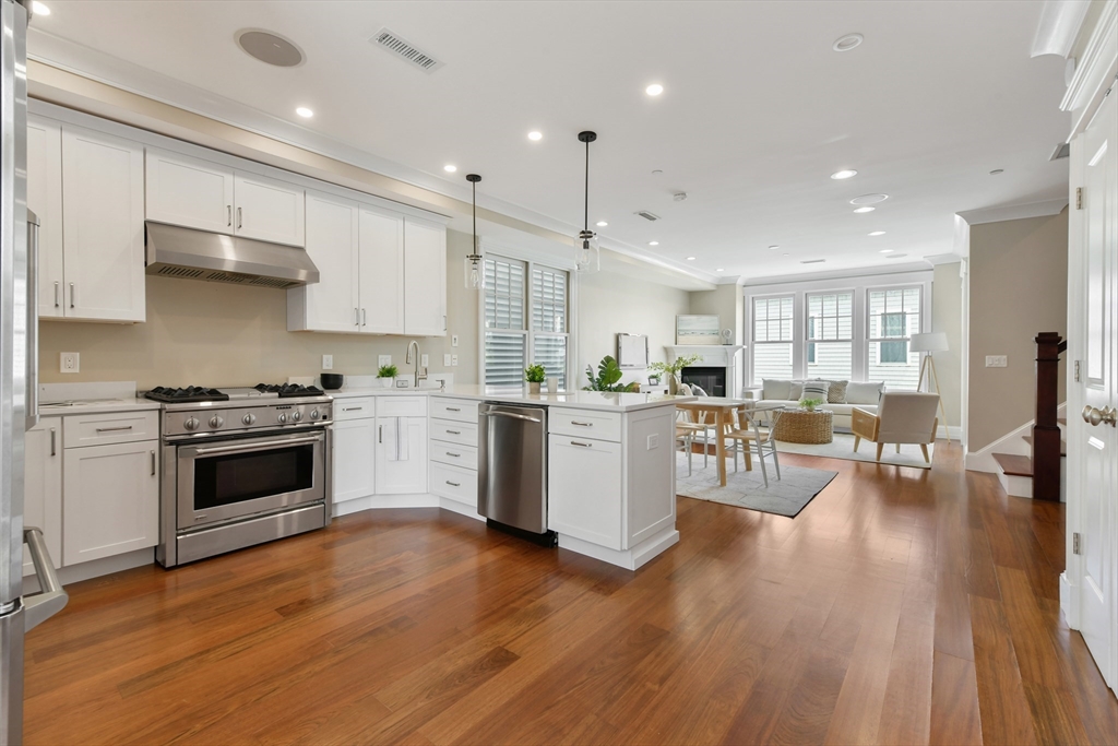 a kitchen with a white stove top oven and cabinets