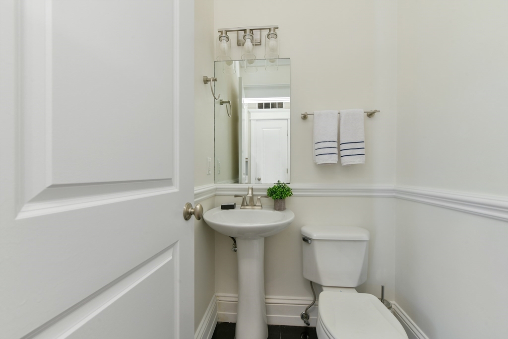 111 Bolton Street, Unit 2 Boston, MA 02127 - Photo 15 of 36 a bathroom with a sink mirror and toilet