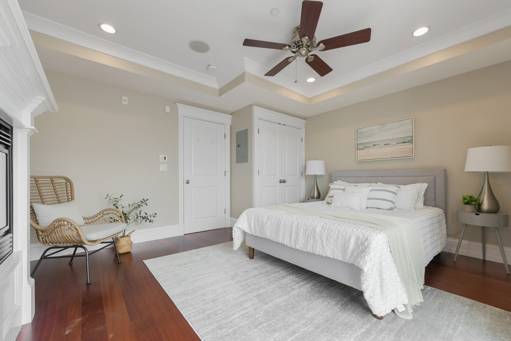 111 Bolton Street, Unit 2 Boston, MA 02127 - Photo 17 of 36 a bedroom with a bed furniture and a chandelier