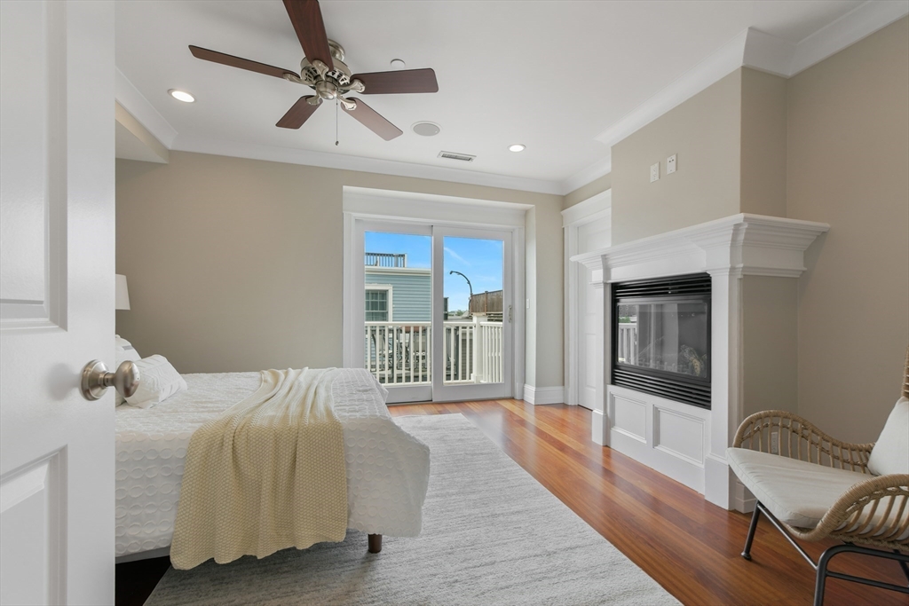 111 Bolton Street, Unit 2 Boston, MA 02127 - Photo 19 of 36 a bedroom with a bed ceiling fan and a window