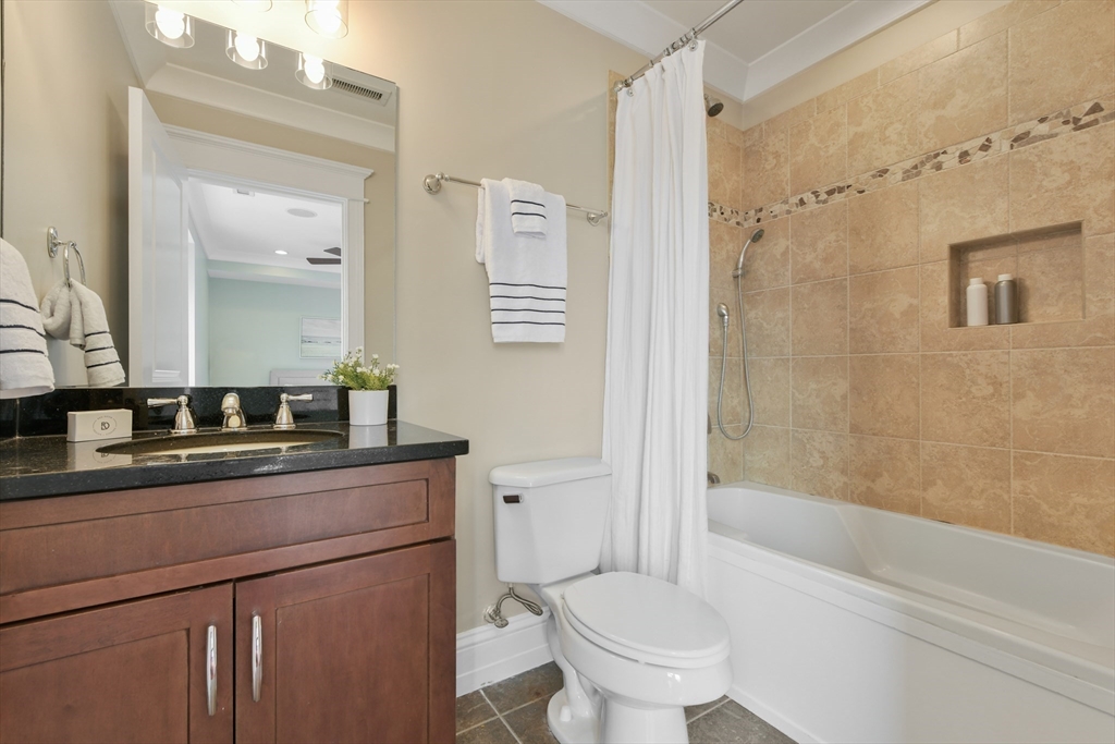 111 Bolton Street, Unit 2 Boston, MA 02127 - Photo 20 of 36 a bathroom with a sink a toilet and shower