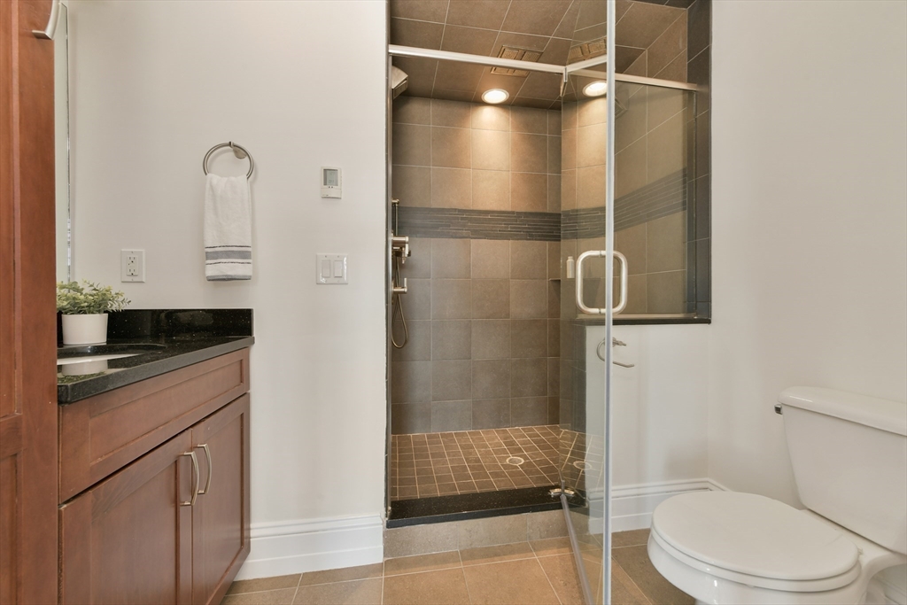 111 Bolton Street, Unit 2 Boston, MA 02127 - Photo 23 of 36 a bathroom with a shower toilet and sink
