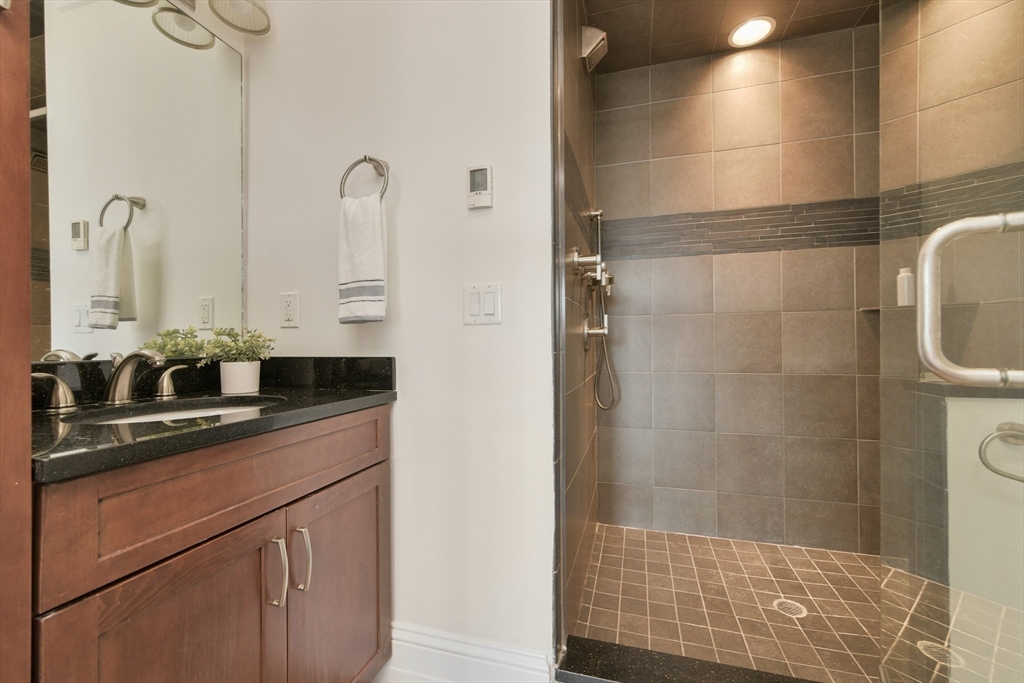 111 Bolton Street, Unit 2 Boston, MA 02127 - Photo 24 of 36 a bathroom with a sink and mirror