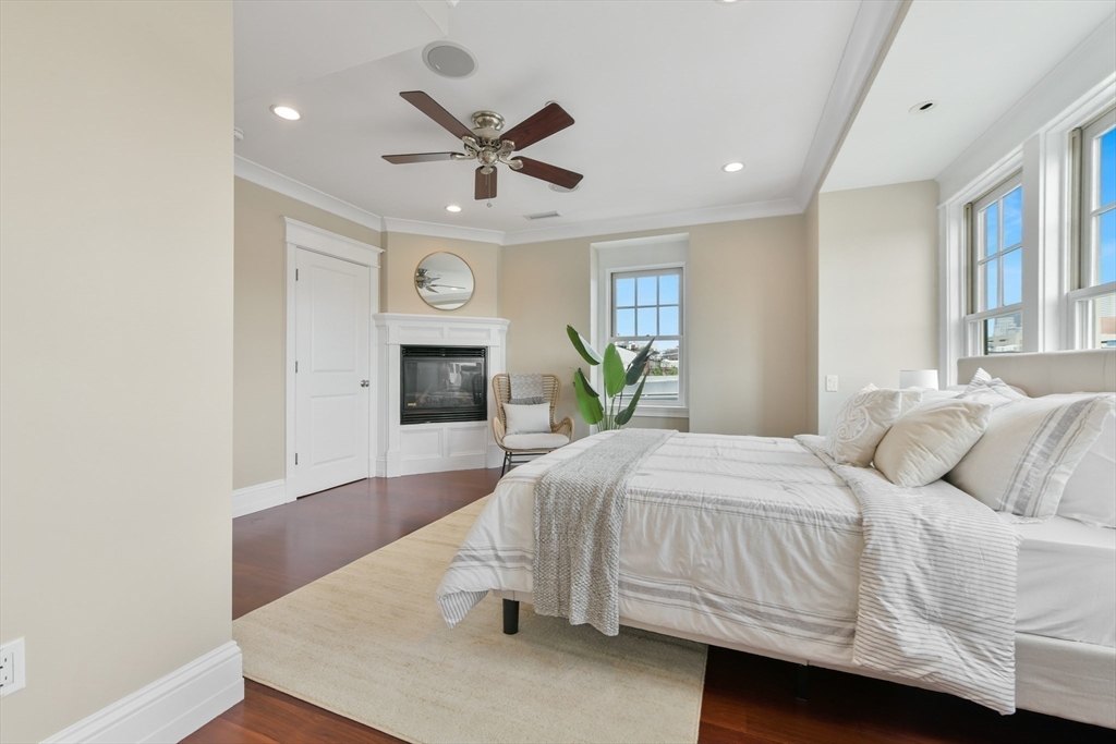 111 Bolton Street, Unit 2 Boston, MA 02127 - Photo 26 of 36 a bedroom with a bed and a chandelier