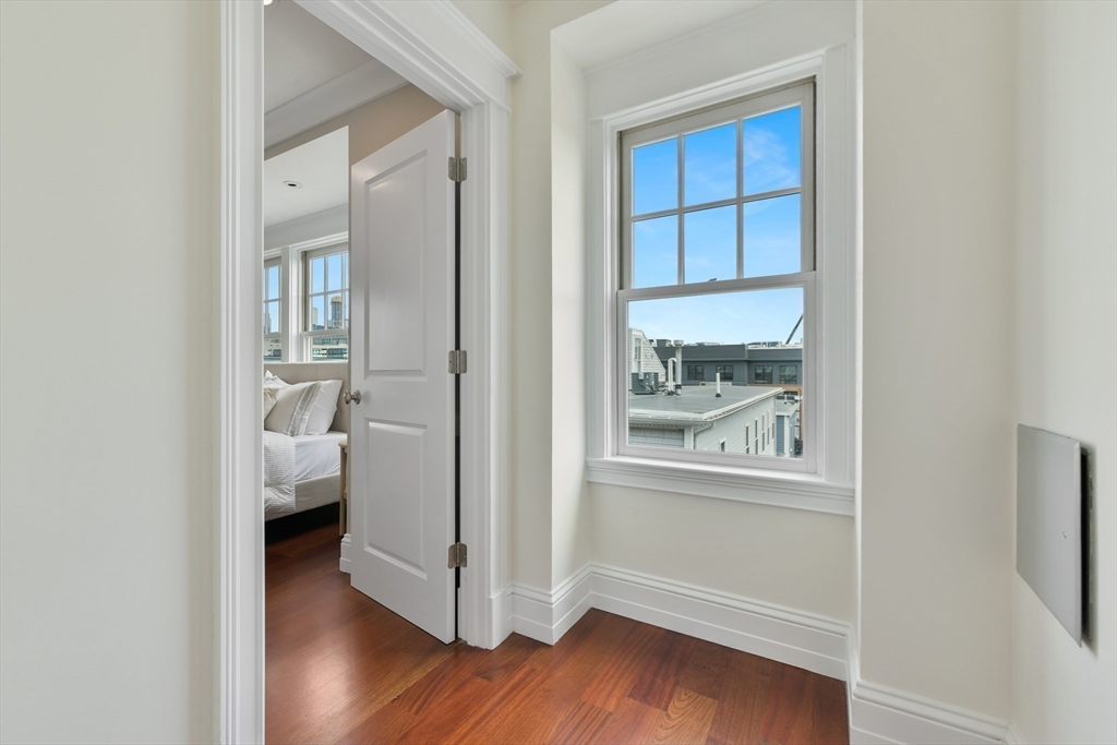 111 Bolton Street, Unit 2 Boston, MA 02127 - Photo 28 of 36 a view of a bedroom with wooden floor and windows