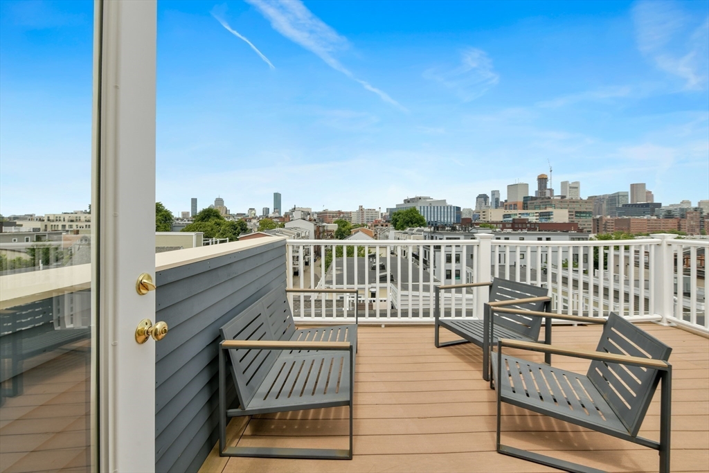 111 Bolton Street, Unit 2 Boston, MA 02127 - Photo 29 of 36 a view of a balcony with wooden floor and fence