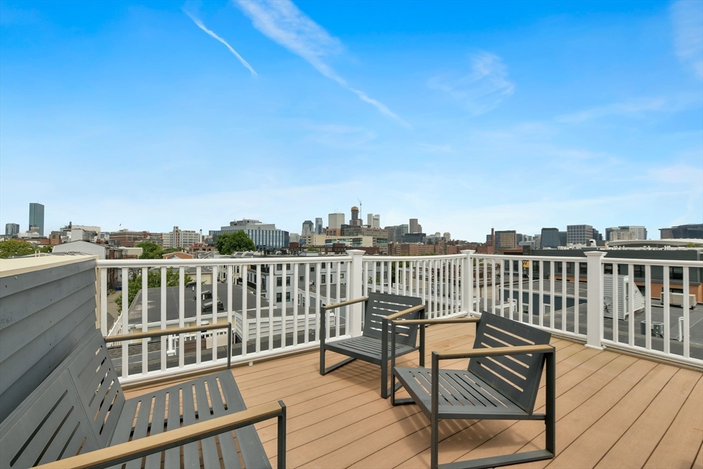 111 Bolton Street, Unit 2 Boston, MA 02127 - Photo 31 of 36 a view of a balcony with wooden chairs