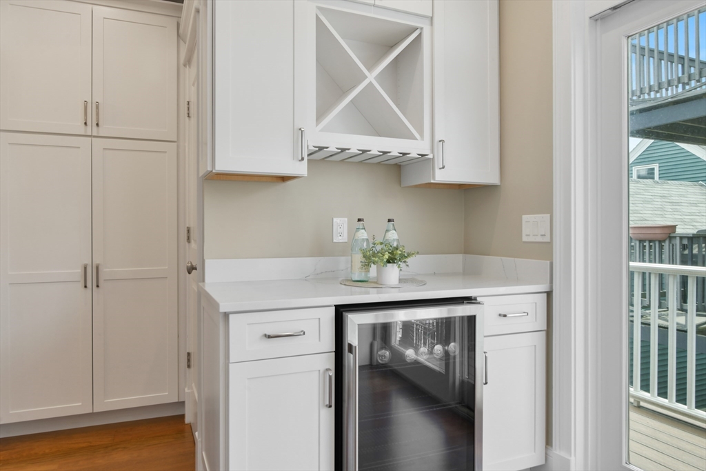 111 Bolton Street, Unit 2 Boston, MA 02127 - Photo 5 of 36 a room with cabinets and a wooden floor