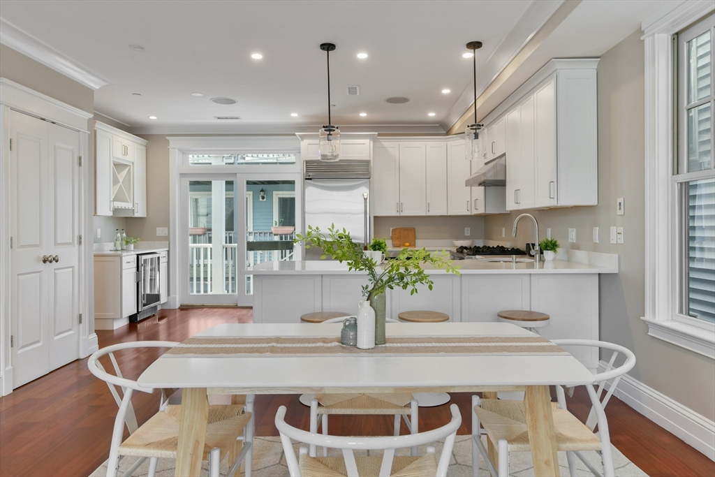 111 Bolton Street, Unit 2 Boston, MA 02127 - Photo 8 of 36 a kitchen with kitchen island a table and chairs