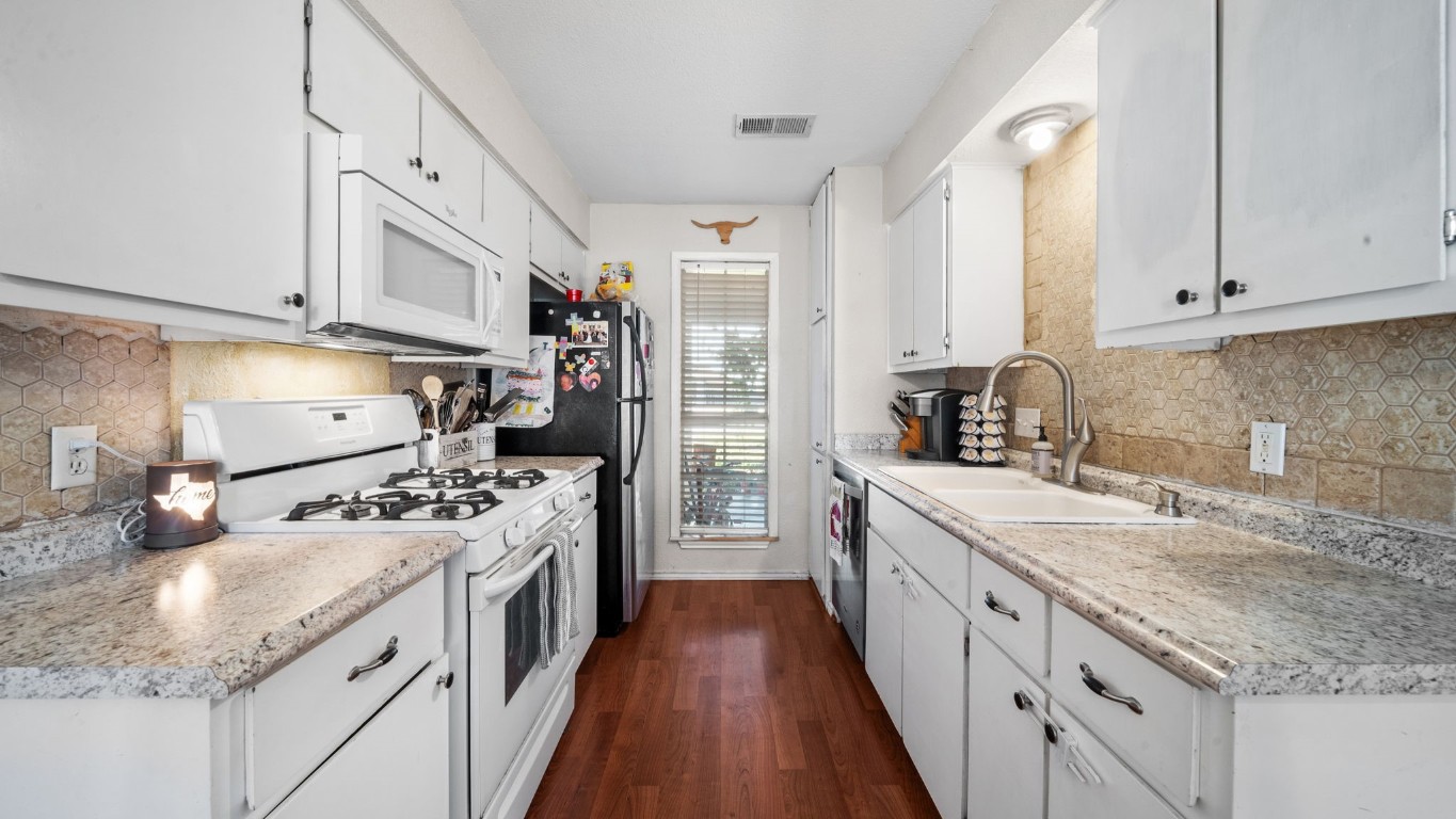 a kitchen with stainless steel appliances granite countertop a lot of counter space sink stove and refrigerator