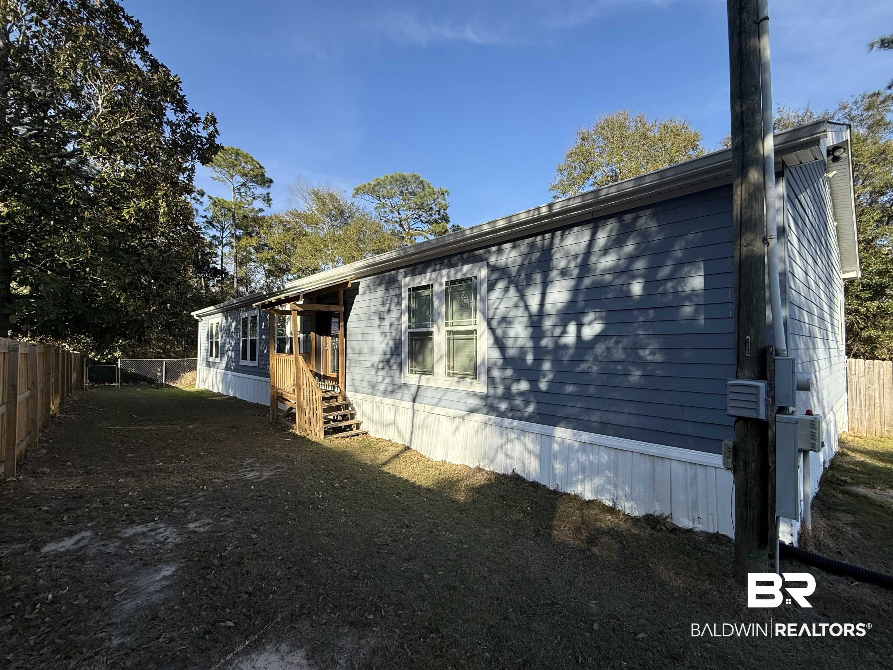 1274 Caney Loop Lillian, AL 36549 - Photo 1 of 19 View of home's exterior with a fenced backyard