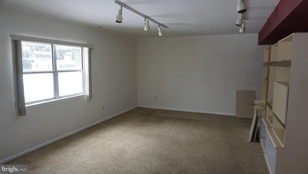 an empty room with a empty space and windows