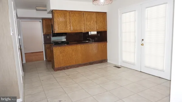 a view of kitchen with granite countertop cabinets