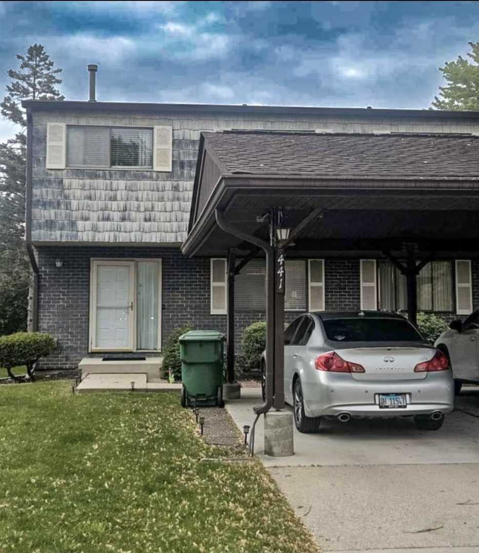 a car parked in front of white building