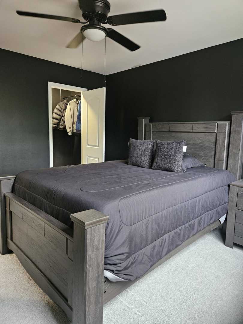 441 Commanche Trail Wheeling, IL 60090 - Photo 12 of 26 a bedroom with a large bed and a ceiling fan