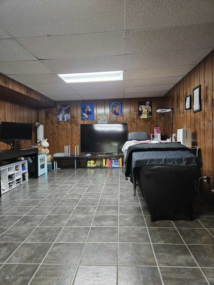 441 Commanche Trail Wheeling, IL 60090 - Photo 22 of 26 a room with gym equipment and a flat screen tv