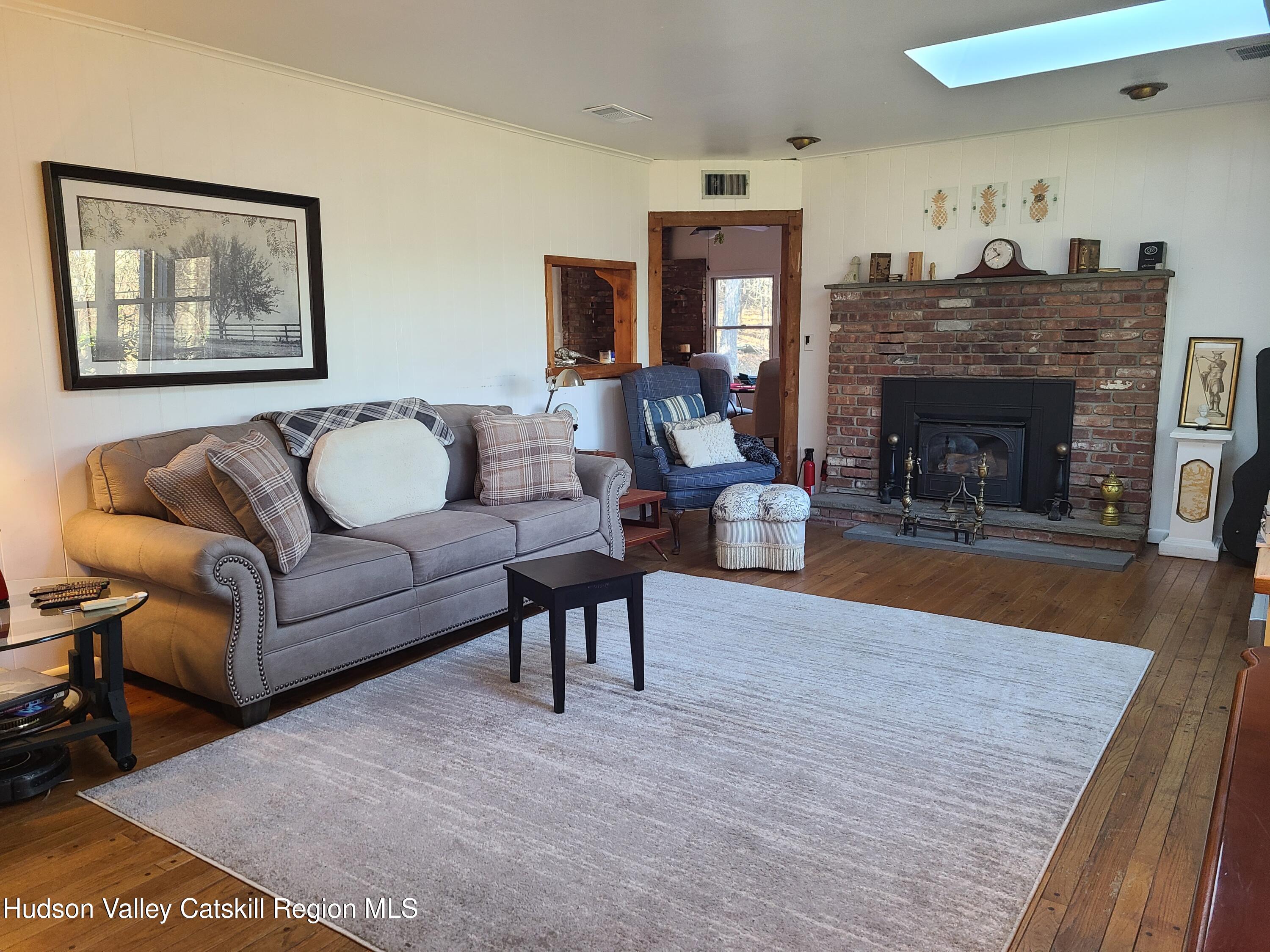44 Sheldon Hill Road Olivebridge, NY 12461 - Photo 16 of 24 a living room with furniture and a fireplace