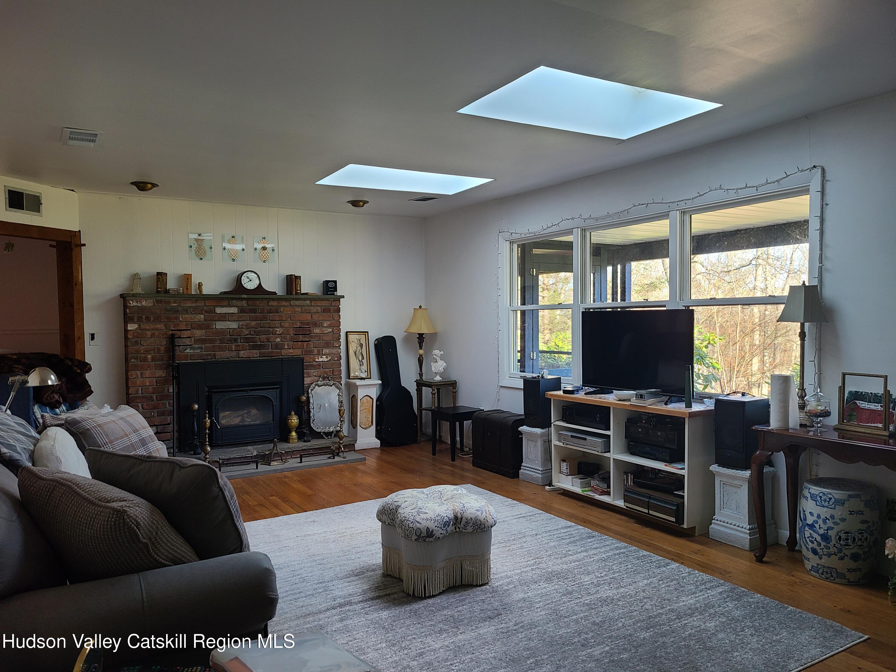 44 Sheldon Hill Road Olivebridge, NY 12461 - Photo 17 of 24 a living room with furniture a flat screen tv and a fireplace