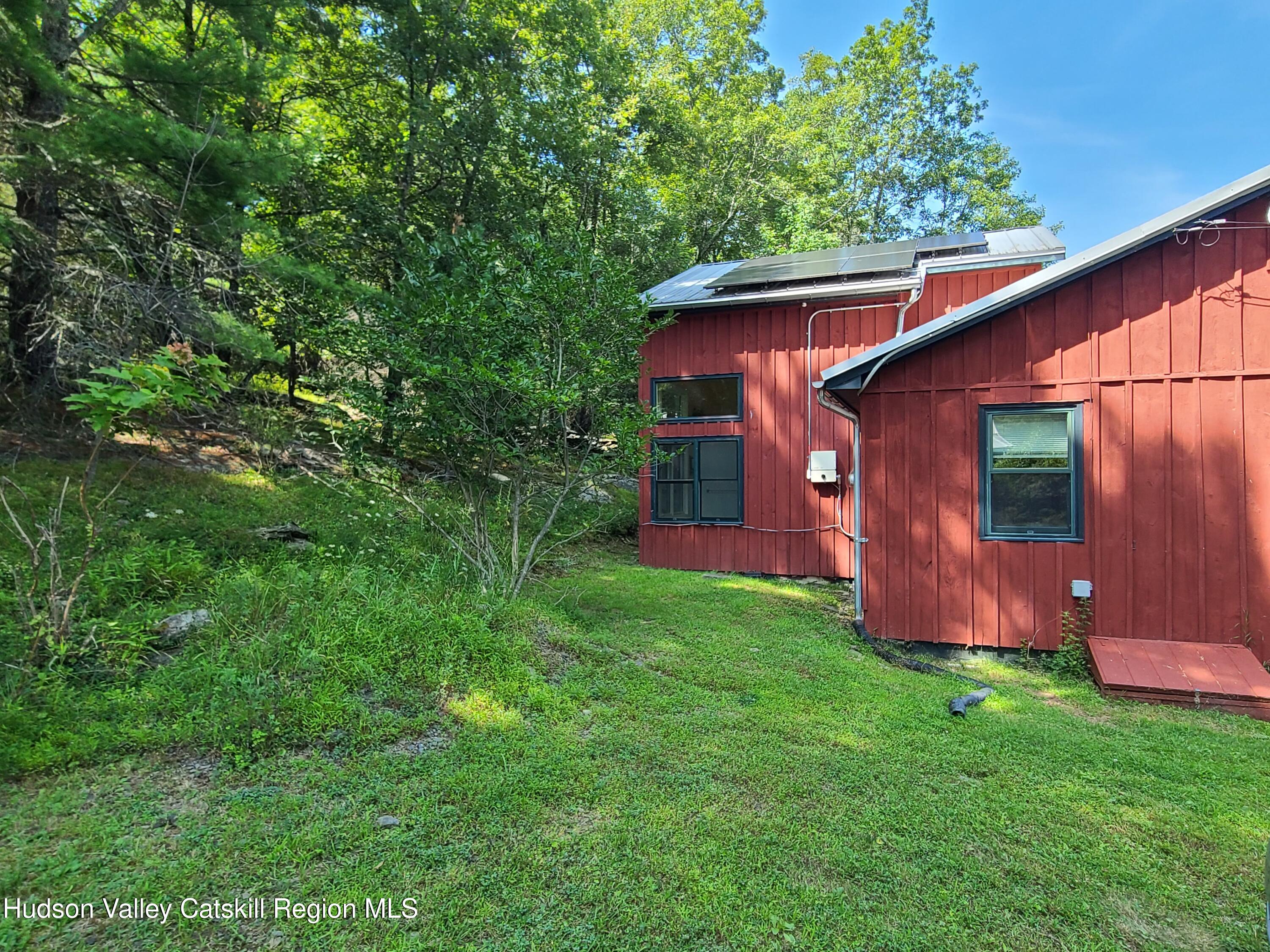 44 Sheldon Hill Road Olivebridge, NY 12461 - Photo 6 of 24 a view of a backyard with potted plants and a large tree