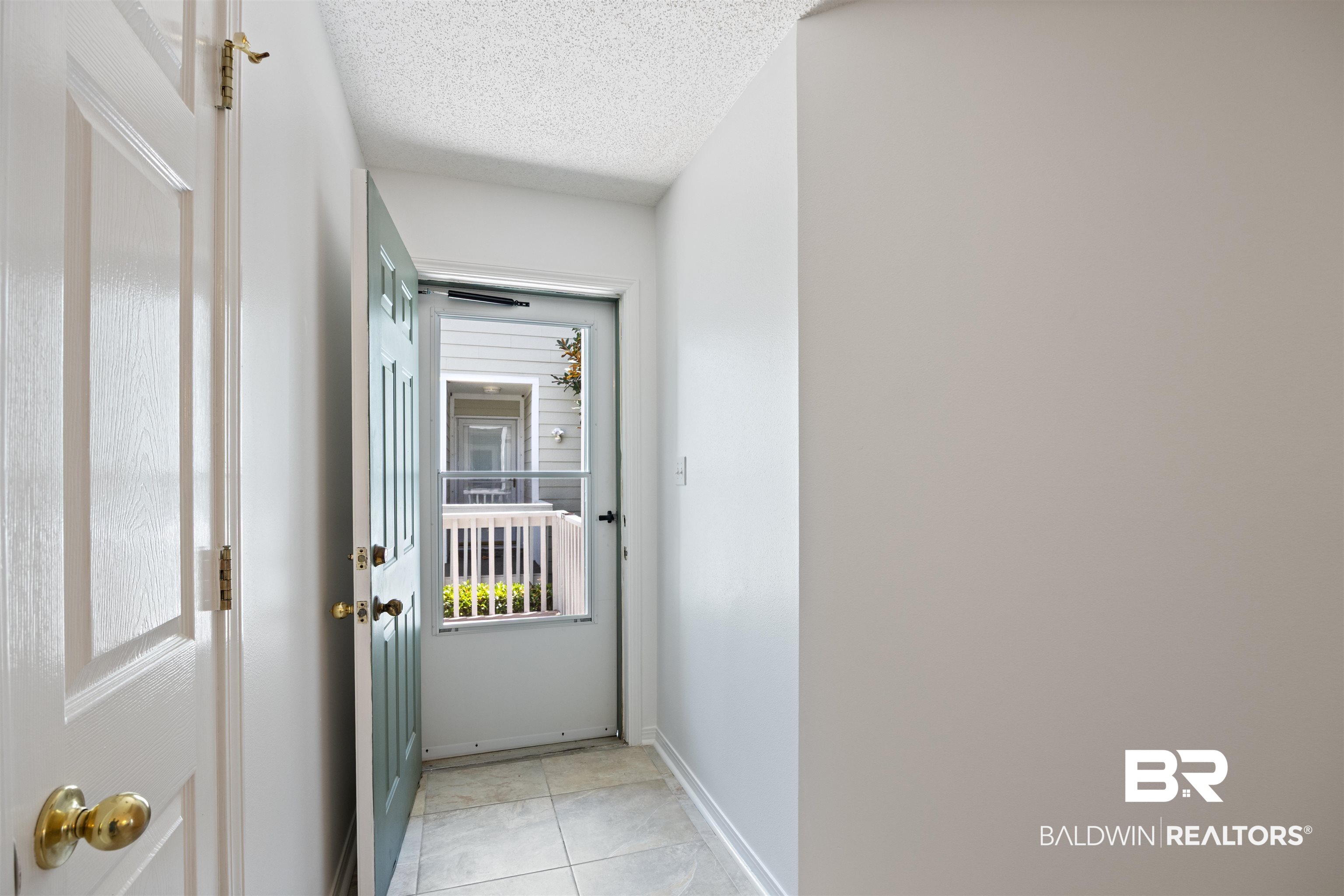 3200 Loop Road, Unit 96 Orange Beach, AL 36561 - Photo 10 of 49 Entryway featuring light-toned tile flooring and a paneled entry door